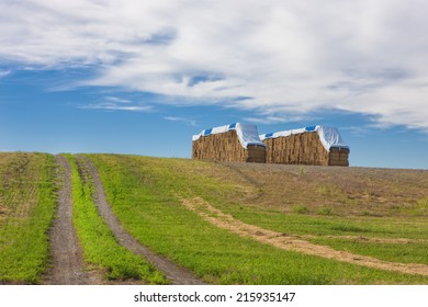 A large haystack in the Rathdrum Prairie under a rich partly cloudy blue sky in North Idaho.
