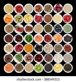 Large health and superfood collection in porcelain crinkle bowls over black background. High in vitamins and antioxidants.