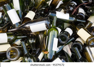 A large heap of empty green wine bottles