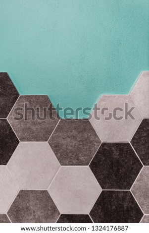 large hexagonal background. Concrete structure, shades of gray. Close-up of hexagon tiles in kitchen. Mint wall
