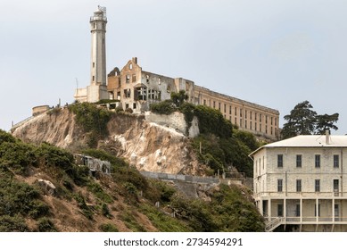 Large historic prison complex built on a steep island slope, overlooking the water and emphasizing remoteness.
