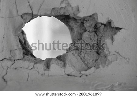 large hole cracks in solid wall isolated on transparent background torn hole in a old cracked concrete wall. Peeling old wall. Cracked and peeling, Grunge wall texture. Worn texture 