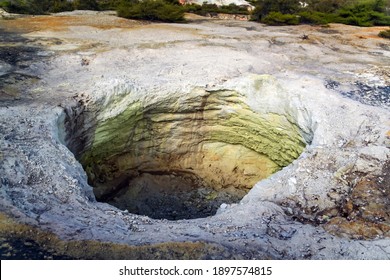 Large Hole In The Ground, Crater With Yellow Green Gray Soil