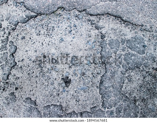 Large hole in the road. Apocalyptic\
texture with chaos and destruction. Stock photo of military\
aftermath of\
infrastructure.