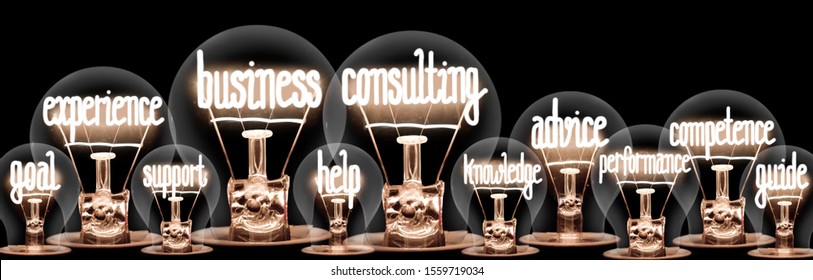 Large horizontal group of light bulbs with shining fibers in a shape of Business Consulting, Help, Support and Experience concept words on isolated on black background.