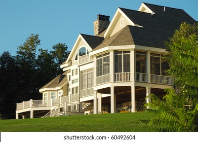 Large House Sitting on top of a Grassy Hill