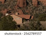 Large house under ceramic tiles roof  on slopes of Red rock cliffs in West Sedona, Arizona