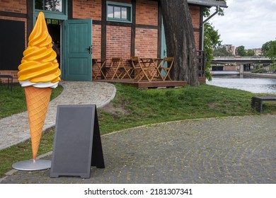 Large Ice Cream Plastic Figure Near The Ice Cream Cafe In The Park. Blank Restaurant Shop Sign Or Menu Board. Cafe Menu On The Street. Blackboard Sign Mockup In Front Of A Restaurant