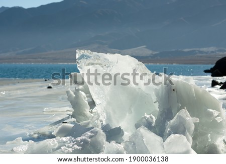 Large ice floes on the shore of a mountain lake. Winter lake in ice.
