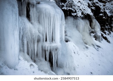 Large Icicles on a ledge surrounded by snow
