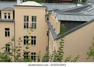 The large, impressive building features a gray roof and is adorned with numerous windows that allow natural light to flood inside