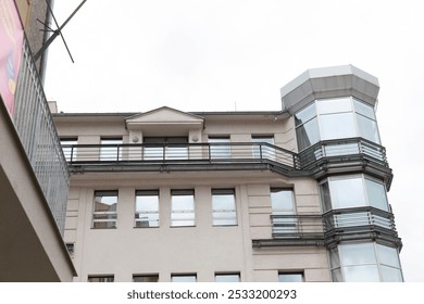 A large and impressive building that features many windows and multiple staircases, creating an appealing structure in the skyline