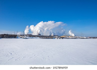 A Large Industrial Complex Against The Backdrop Of A Bright Blue Sky.