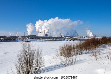 A Large Industrial Complex Against The Backdrop Of A Bright Blue Sky.