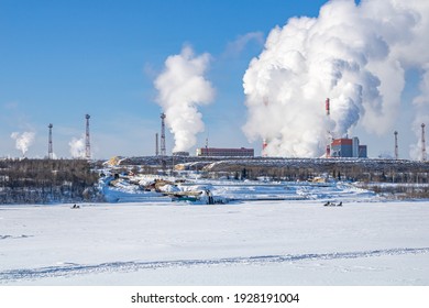 A Large Industrial Complex Against The Backdrop Of A Bright Blue Sky.