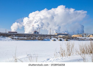 A Large Industrial Complex Against The Backdrop Of A Bright Blue Sky.