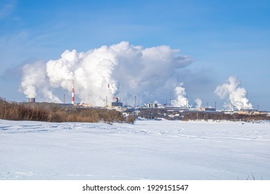 A Large Industrial Complex Against The Backdrop Of A Bright Blue Sky.