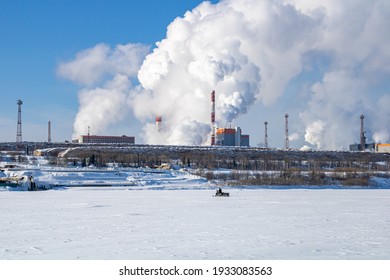 A Large Industrial Complex Against The Backdrop Of A Bright Blue Sky.