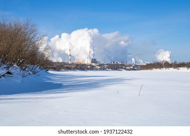 A Large Industrial Complex Against The Backdrop Of A Bright Blue Sky.