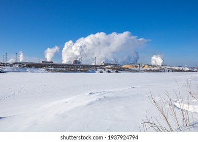 A Large Industrial Complex Against The Backdrop Of A Bright Blue Sky.