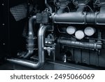 Large industrial diesel engine or diesel generator close-up with many pipes and other parts. Industrial concept background