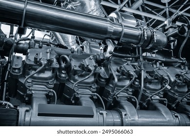 Large industrial diesel engine or diesel generator close-up with many pipes and other parts. Industrial concept background - Powered by Shutterstock