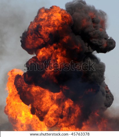 Large industrial fire with thick black smoke