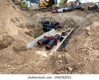 Large industrial modern new large diameter polyethylene plastic water pipes lie in a pit underground at a construction site during a water pipe repair.