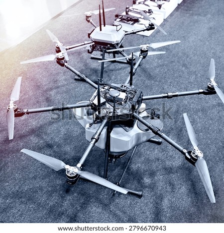 Large industrial multirotor drone with multiple propellers showcased at a technology exhibition. Advanced unmanned aerial vehicle designed for surveying, inspection, mapping, monitoring, and commercial operations.
