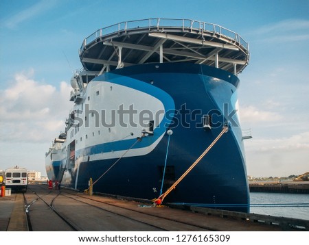 Large industrial seismic survey vessel ship in port at pier, sea exploration, oil research and mining offshore transport.