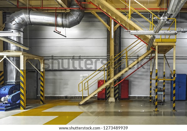 Large industrial ventilation pipes inside car\
plant, industrial\
interior