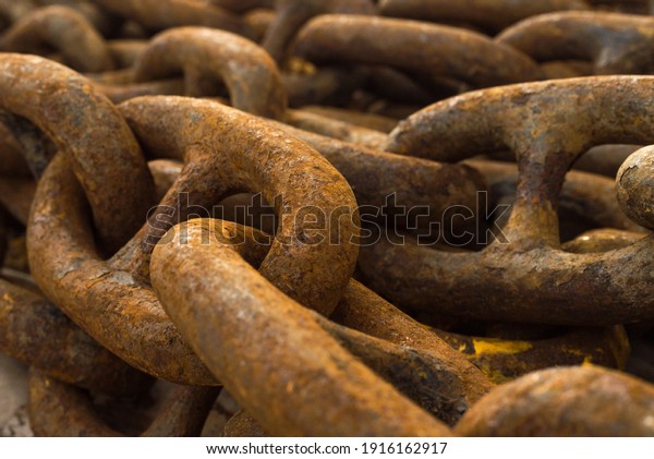 Large iron anchor chain. A rusty chain link.\
Corrosion. Shackles.