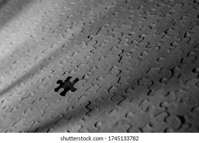 Large jigsaw puzzle with a piece missing in monochrome black and white. - Shutterstock ID 1745133782