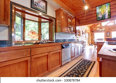 Large Kitchen Log Cabin House Interior With Orange Wood.