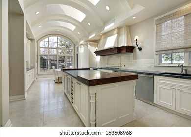 Large kitchen in luxury home with curved ceiling