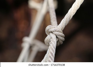 Large Knot Made Of Natural Hemp. The Know It Part Of Kids' Playground Equipment In Switzerland. A Know Is A Symbol For Nautical Life, Cooperation, Harmony, Connection, Being Together, Etc. Closeup.