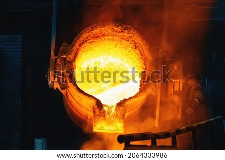 Large ladle with molten liquid metal in steel mill metallurgical foundry