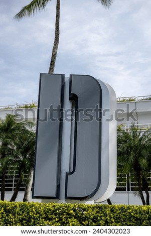 Large letter D sign with palm trees in background