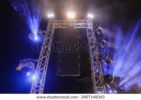 Large light and loudspeaker installation poles at concerts