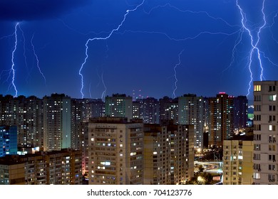 A lot of large lightning bolts in the sky above the city. Wonders of nature.