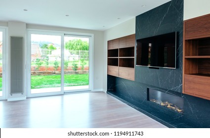 Large Living Room Empty With Fireplace And TV