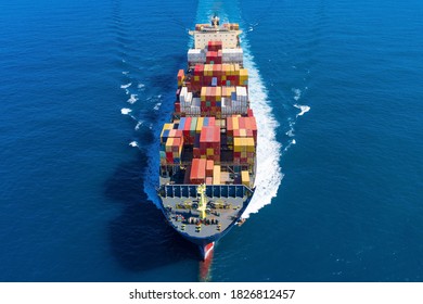 Large Loaded Container Ship Sailing Across The Ocean, Aerial View.