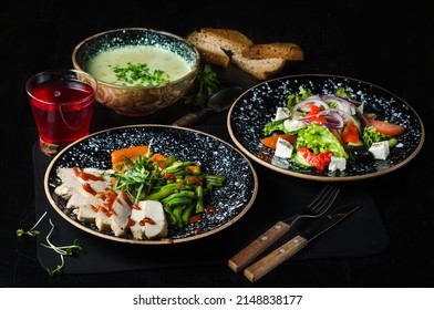 Large Lunch Set Of Three Courses Soup, Second Course And Salad. Business Lunch Set Made Of Three Meals. Greek Salad, Puree Soup, Chicken Fillet With Vegetables And Puree Soup.