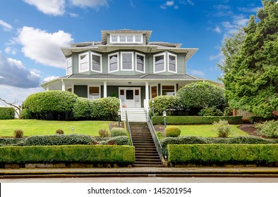 Large luxury green craftsman classic American house exterior.