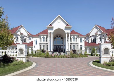 Large Luxury Home With Arched Entry And Tiled Roof