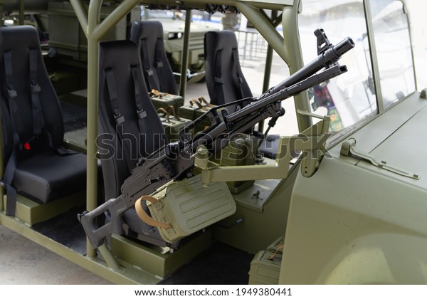 A large machine gun\
mounted on a military vehicle. Modern weapons of light artillery.\
Close-up. No people