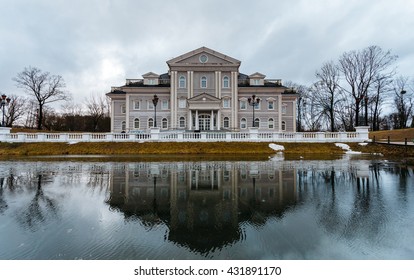 Large Mansion Or House Stands On The Former Site Of The Fortress With A Moat. Front Of The House Is Reflected In The Water.