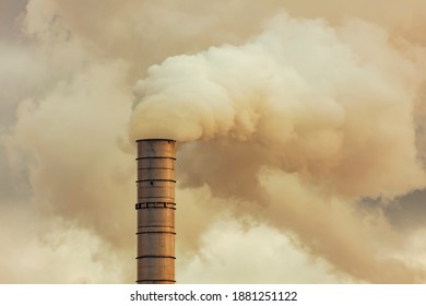 A Large Manufacturing Facility In A Regional Township With Steam Coming From The Chimney Stacks During Processing