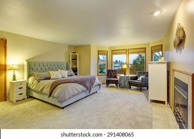 Large Master Bedroom With Fireplace And Bed.