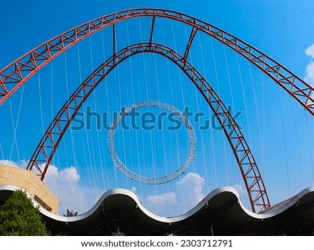 A large metal arching structure and blue sky background, Ancol gateway, Jakarta, Indonesia